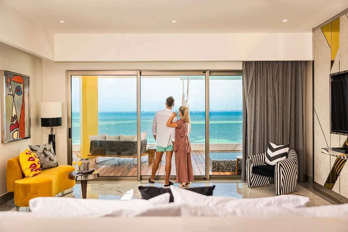 couple at their ocean view hotel mousai cancun suite