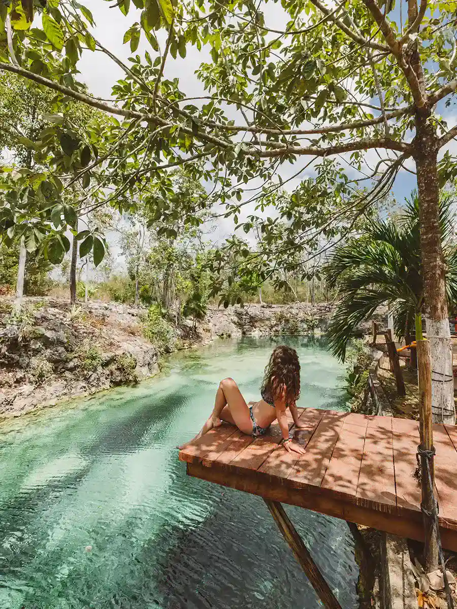 Girl relaxing by an ancient and beautiful Mayan river